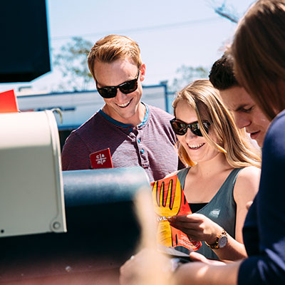 Excited students getting mail from a mailbox